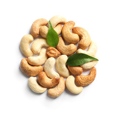 Tasty cashew nuts and leaves isolated on white, top view
