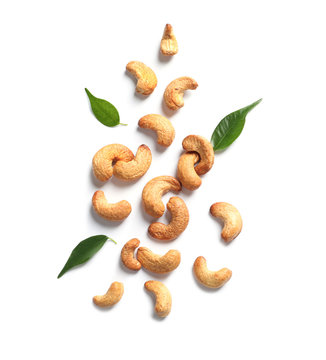 Tasty cashew nuts and leaves isolated on white, top view