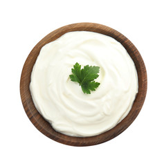Bowl with sour cream and herbs on white background, top view