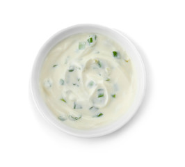 Bowl with sour cream and herbs on white background, top view