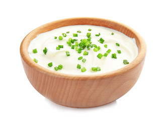 Bowl with sour cream and herbs on white background
