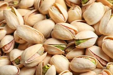 Organic pistachio nuts in shell as background