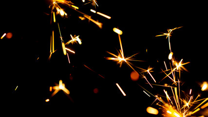 Christmas sparkler isolated on black background. Bengal fire