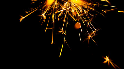 Fototapeta premium Christmas sparkler isolated on black background. Bengal fire
