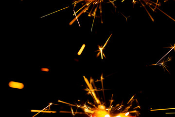 Christmas sparkler isolated on black background. Bengal fire