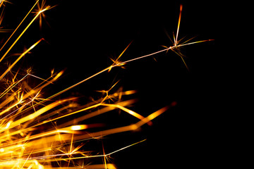 Christmas sparkler isolated on black background. Bengal fire