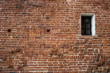 Fototapeta na wymiar Old brick wall with brick filled window.
