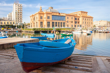 Fototapeta na wymiar Little Harbor with wooden boats and theater in the background, Bari, Puglia, Italy