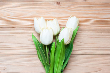 Top view white tulip flowers on wooden table. love, romantic and Valentine Day holiday Concept