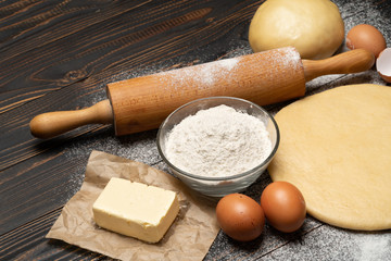 rolled and unbaked Shortcrust pastry dough recipe on wooden background