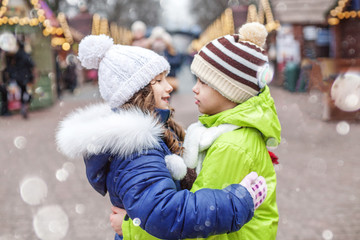 Little boy and girl hug on the street. The concept of lifestyle, love, Valentine's Day.