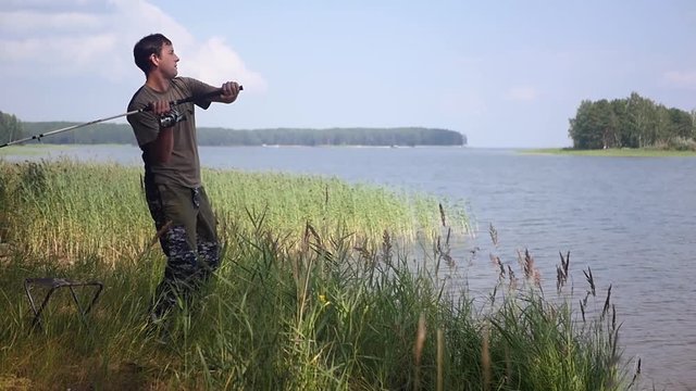 Male fisherman actively fishing. Soon catch fish. 1920x1080, full hd