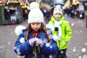 Happy child girl received a rose as a gift. The concept of lifestyle, love, Valentine's Day.