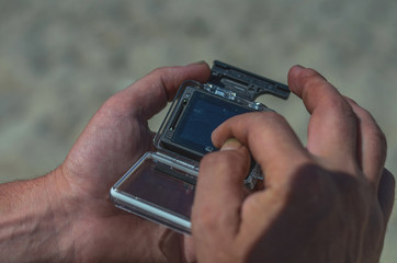 hand with digital action camera 