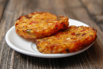 Crispy roasted vegetarian burger made from various type of vegetables on old wooden table