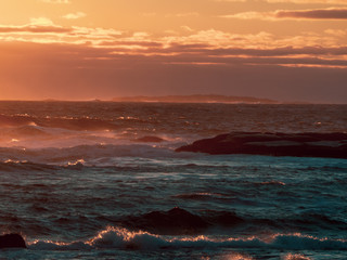 Fototapeta premium Winter waves at Peggy's Cove in Nova Scotia during sunset, peaceful, waves, powerful.