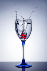 red wine splash in glass isolated on white