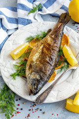 Baked lake trout with lemon and dill.