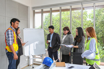 Engineers are meeting on the whiteboard. Blueprint Interior Design structure and development. contractor presentation for team and client in the office. Asian people.