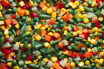 Fresh steamed vegetables corn, green peas, peppers, green beans, carrot, onions closeup. Organic vegetables, detox diet