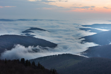 Beautiful sunrise in the Skole Beskydy with fantastic beauty over the sky, and the fog sea around the majestic Carpathian Mountains.