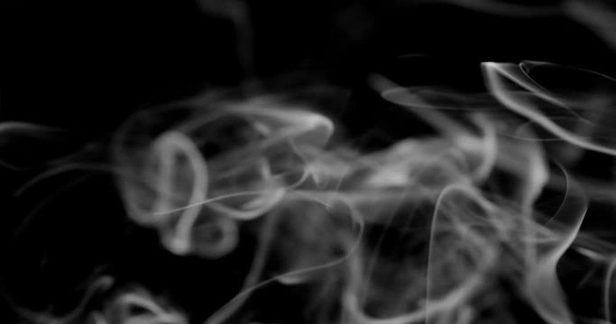 Smoke background. White smoke floating through space against black background	