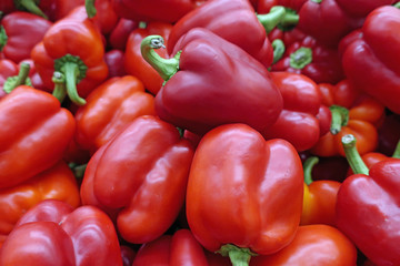 many scattered ripened red pepper fruits in the store