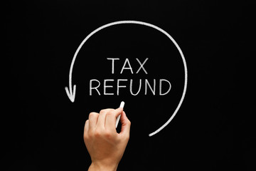 Tax Refund Arrow Concept On Blackboard