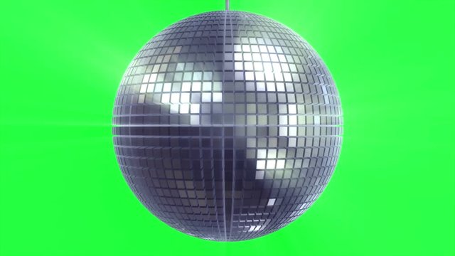 Rotating and glowing disco ball on green