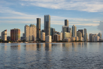 Fototapeta na wymiar Miami, Florida 09-08-2018 City of Miami skyline and its reflection on the tranquil water of Biscayne Bay.