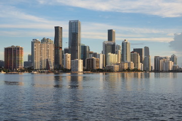 Fototapeta na wymiar Miami, Florida 09-08-2018 City of Miami skyline and its reflection on the tranquil water of Biscayne Bay.