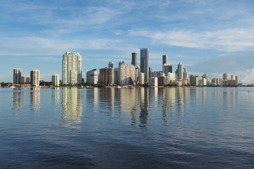 Miami, Florida 09-08-2018 City of Miami skyline and its reflection on the tranquil water of Biscayne Bay.