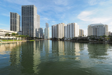 Obraz na płótnie Canvas Miami, Florida 09-08-2018 Buildings of the City of Miami and Brickell Key and their reflections on the tranquil water of Biscayne Bay.