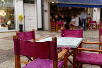 Rain in Blois, wet chairs and tables in an outdoor cafe. Close-up.