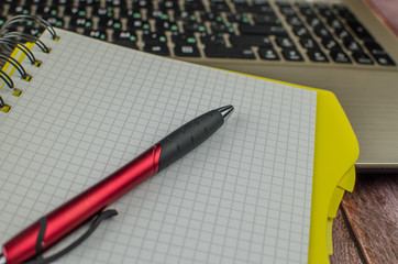 Pen and notebook on laptop. copy space