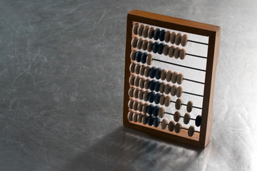 Wooden abacus on a metal surface