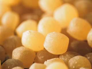 Close up view of ptitim pasta texture background. Ptitim or couscous is traditional israeli food. Dry or raw ptitim with copy space for text.