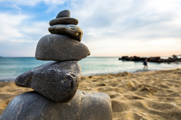 Fototapeta na wymiar Stone cairn at the beach, concept of balance