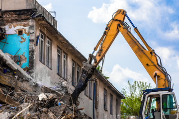 Fototapeta na wymiar demolition of a building with a hydraulic excavator