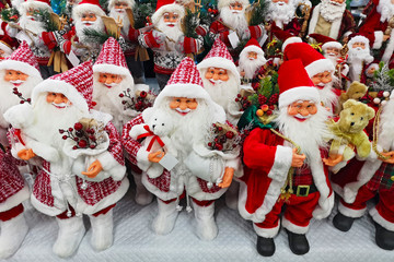 Santa Claus toy in supermarket. Santa's Christmas toys, gifts and souvenirs to decorate the Christmas tree on the counter in a store or supermarket. Santa Claus Toys are sold in the store