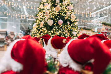 Several small toy Santa Clauses stand in a group