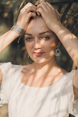 Obraz premium Sexy sensual portrait of a girl, Model in white dress on the background of reeds 