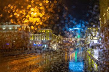 View from the car. Raindrops on the glass. Evening in the city. Norilsk