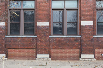 Fototapeta na wymiar Side of red brick building with clean windows