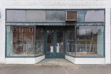 Large window storefront with green and white paint