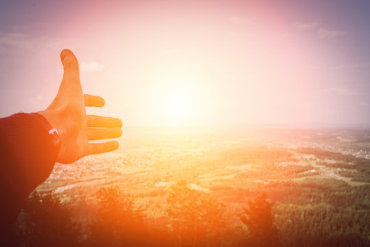 hand man pointing with to sunset in  mountainous area, relax concept and travel. Beautiful sunset