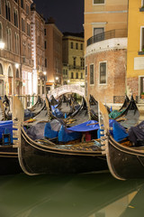 Fototapeta na wymiar Night view of the water widening of the Orseolo basin located in Venice in the San Marco district, Italy. Mirror of water with Gondolas.