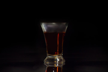 Isolated shot of whiskey with splash on black background