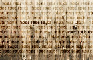 Text Reduce Reuse Recycle burned into Wooden Background.
