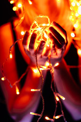 portrait of a girl with a garland on black background